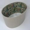 Handmade oval lampshade with natural linen exterior and William Morris Golden Lily floral fabric lining