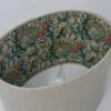 Handmade oval lampshade with natural linen exterior and William Morris Golden Lily floral fabric lining