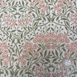 William Morris Michaelmas Sunshine cotton fabric featuring coral-pink floral blooms with sage green foliage on an ivory background.