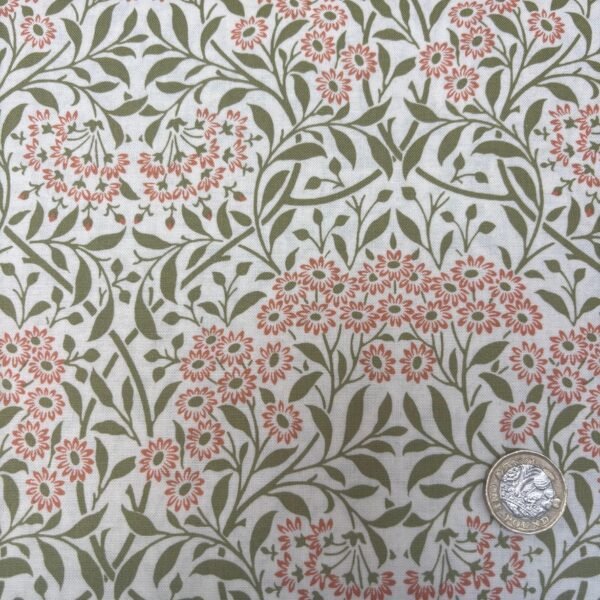 William Morris Michaelmas Sunshine cotton fabric featuring coral-pink floral blooms with sage green foliage on an ivory background.