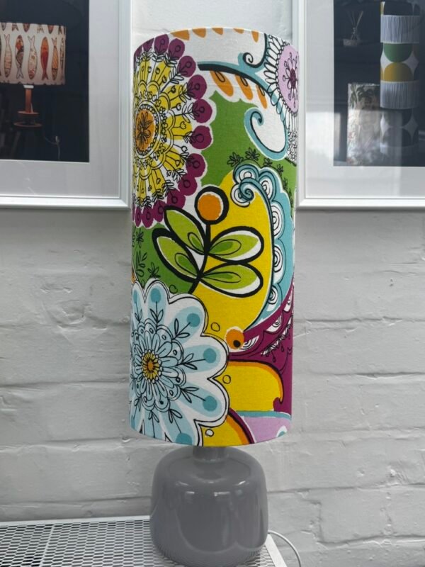Calvados colourful tall cylinder lampshade featuring bold floral patterns in yellow, green, pink and turquoise