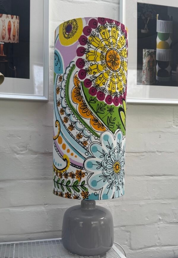 Side view of Calvados tall cylinder lampshade showing colourful botanical flowers and swirling patterns